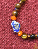 Chapelet Tibétain mala en oeil de tigre. La Magie du Bouddha.