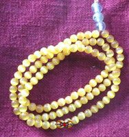 Chapelet Bouddhiste en perles de verre orange opalisé. magiedubouddha