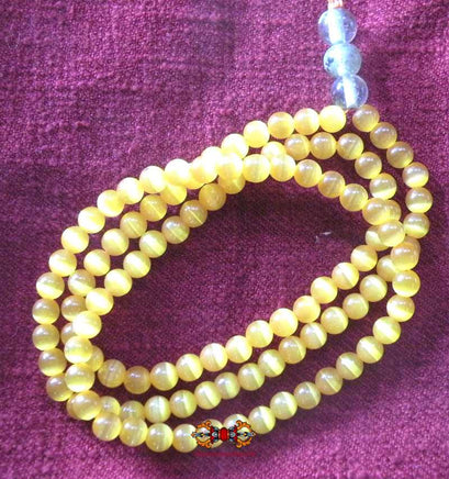 Chapelet Bouddhiste en perles de verre orange opalisé. magiedubouddha