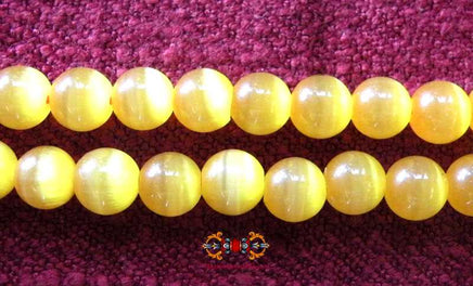 Chapelet Bouddhiste en perles de verre orange opalisé. magiedubouddha