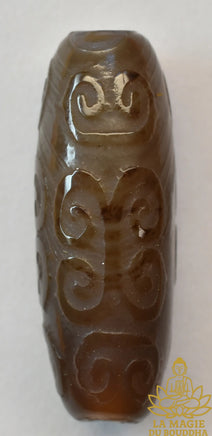 Perle tibétaine en agate sculptée à motifs sacrés La Magie du Bouddha.