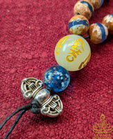 Handmade Tibetan mala for the Medicine Buddha Sangye Menla mantra in blue banded agate and Ye Ming Zhu stone
