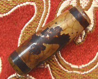 Ancient sacred Dzi bead decorated with a dragon