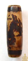 Ancient sacred Dzi bead decorated with a dragon