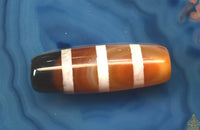 Perle sacrée tibétaine Dzi rayé en cornaline