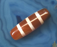 Perle sacrée tibétaine Dzi rayé en cornaline