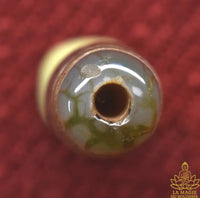 Perle sacrée tibétaine Dzi artisanale au symbole de l’infini La Magie du Bouddha.
