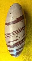Sacred Shiva Lingam in natural stone with brown bands