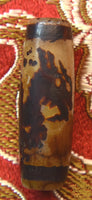 Ancient sacred Dzi bead decorated with a dragon