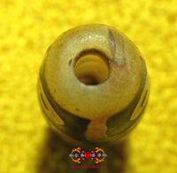 Small sacred Tibetan Dzi beads with nine eyes.