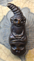 Amulette Phra Ngang assis sur un crâne en alliage alchimique mekkapat