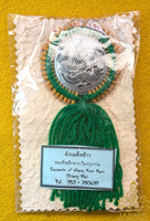 Traditional Thai good luck charm engraved with a Naga and grains of rice