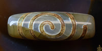 Perle sacrée tibétaine Dzi en agate – Motif spirale (évolution et énergie vitale) La Magie du Bouddha.