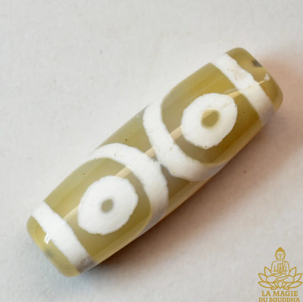 Amulette tibétaine perle Dzi trois yeux en agate translucide beige La Magie du Bouddha.
