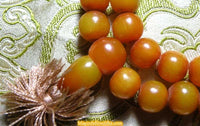 Large Tibetan mala in amber-colored resin. 