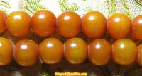 Large Tibetan mala in amber-colored resin. 